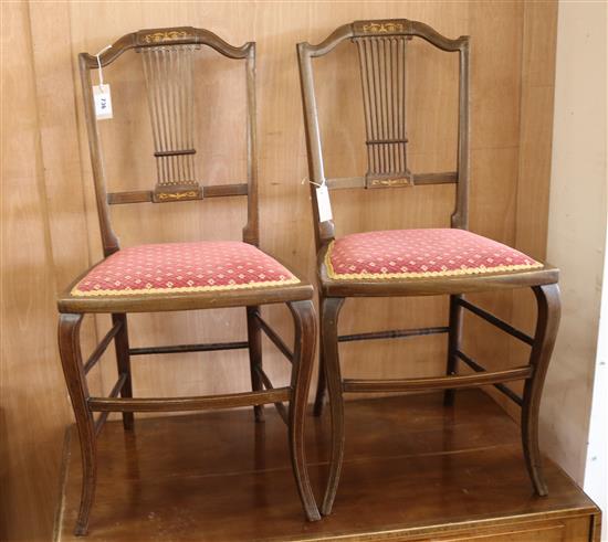 An Edwardian mahogany tub shaped armchair and a pair of inlaid bedroom drawers